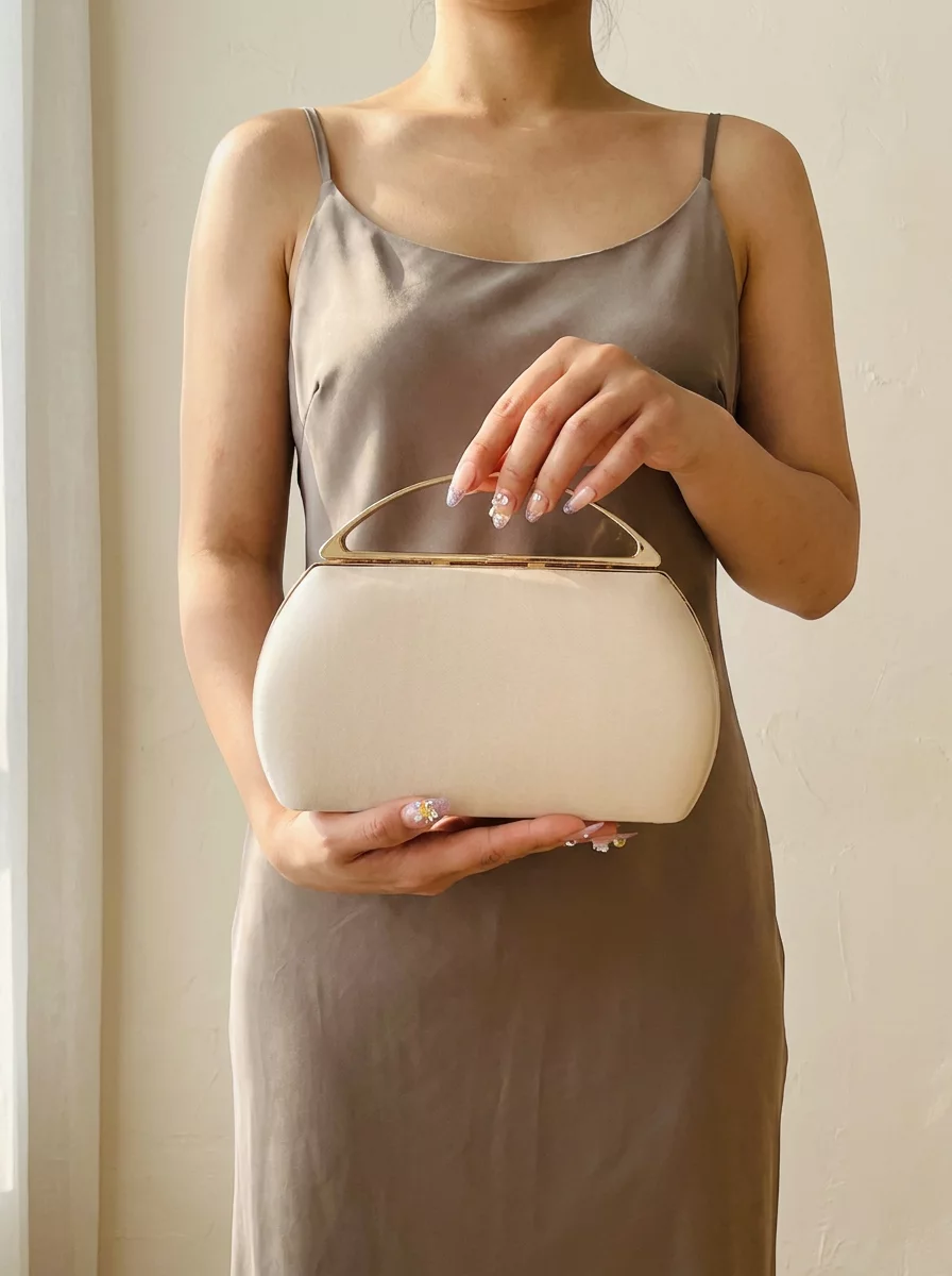Champagne satin clutch with gold top handle